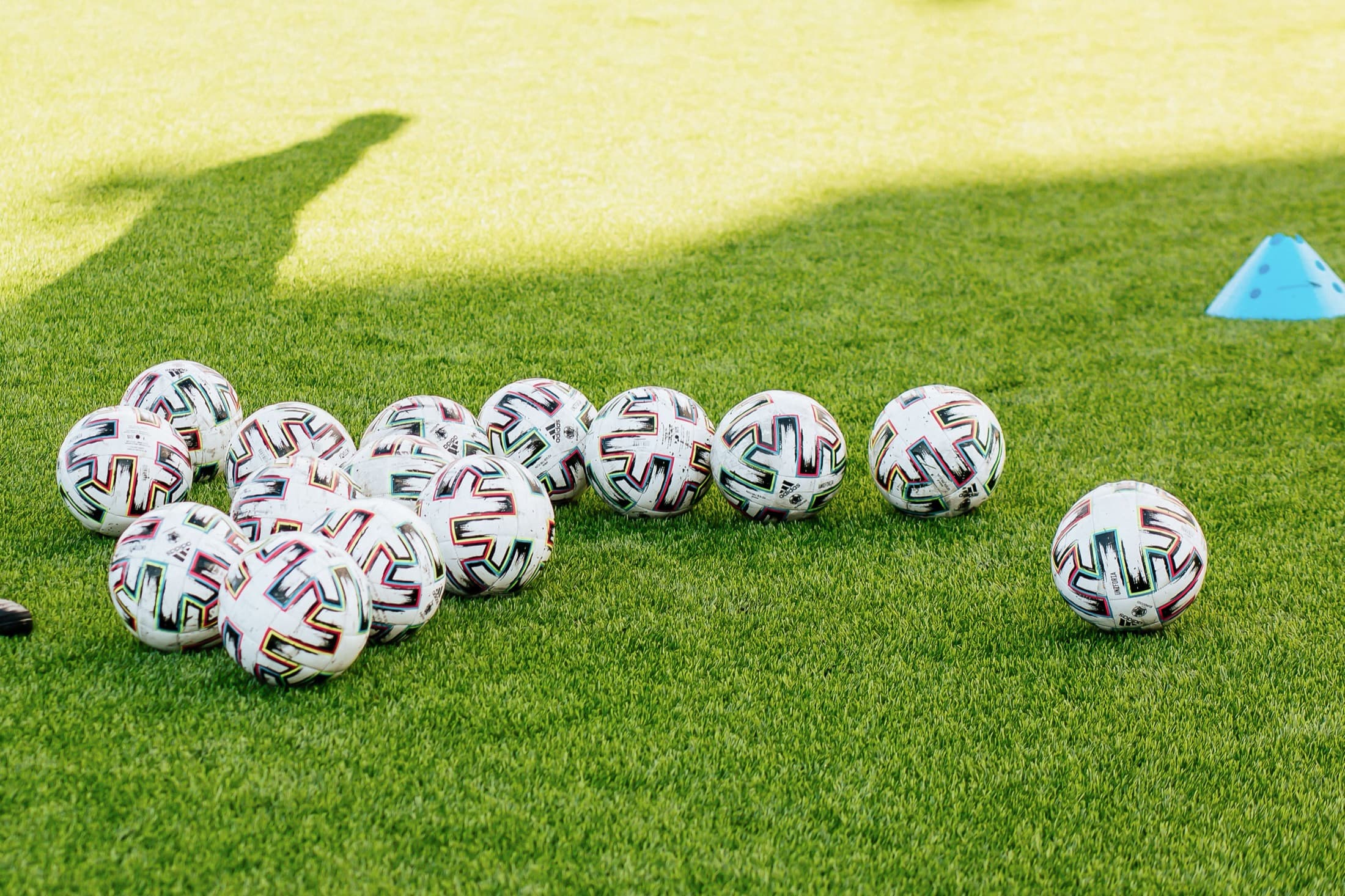 Training balls and a cone set out on the field