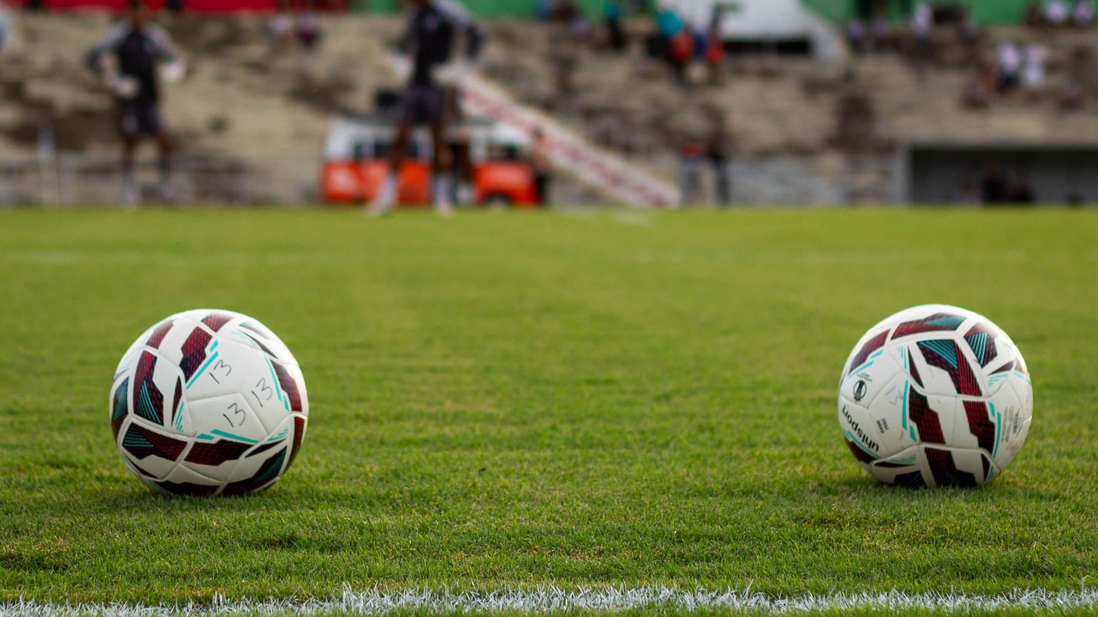 Match balls resting on a stadium pitch